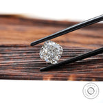 Side angled cushion brilliant diamond held with tweezers