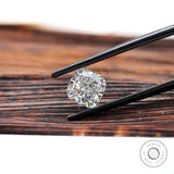 Side angled cushion brilliant diamond held with tweezers