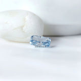 Blue radiant cut lab diamond beside neutral display stones