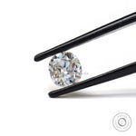 Front view DEF elongated cushion loose moissanite in tweezers