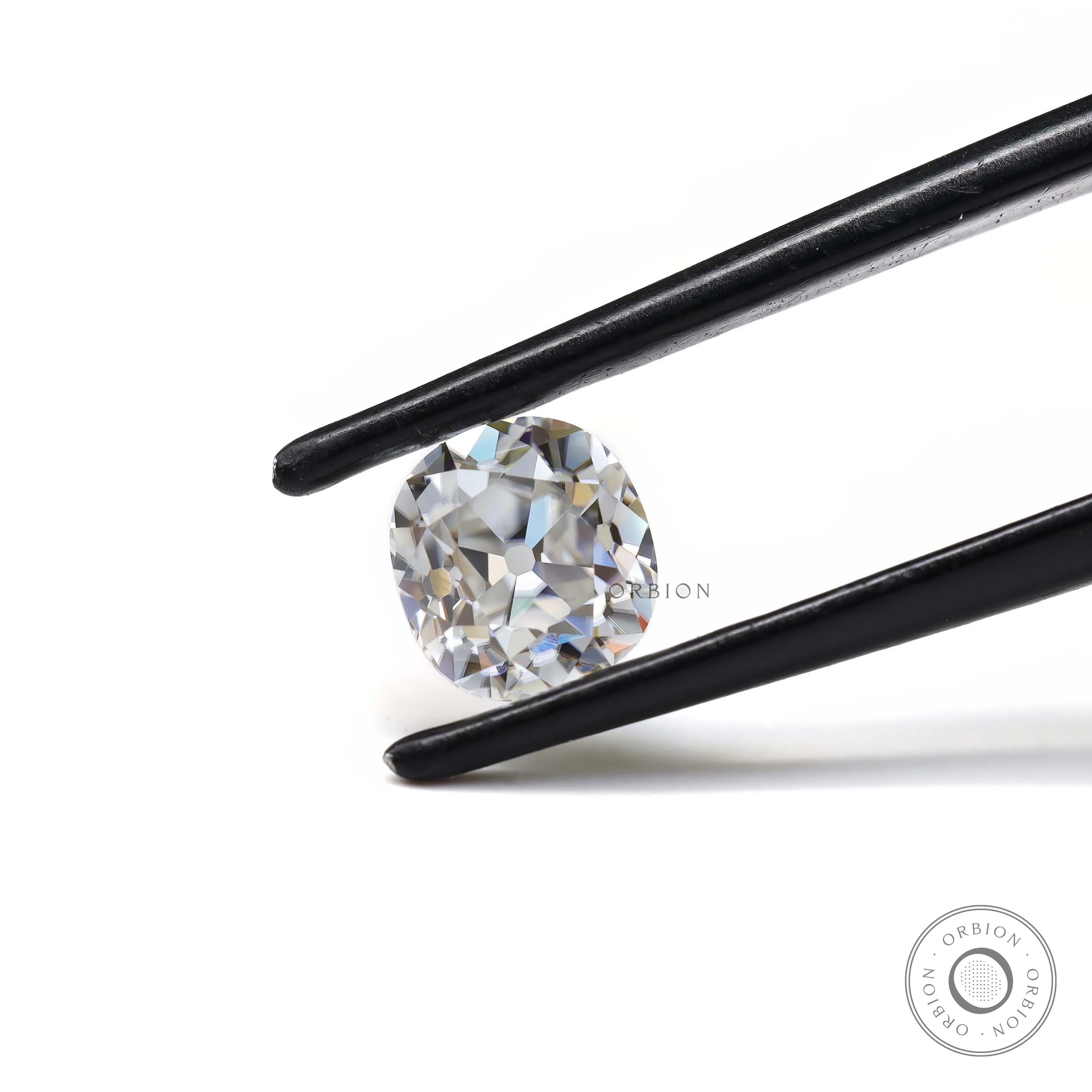 Front view DEF elongated cushion loose moissanite in tweezers