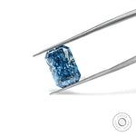 Radiant blue lab diamond tilted in tweezers on white background