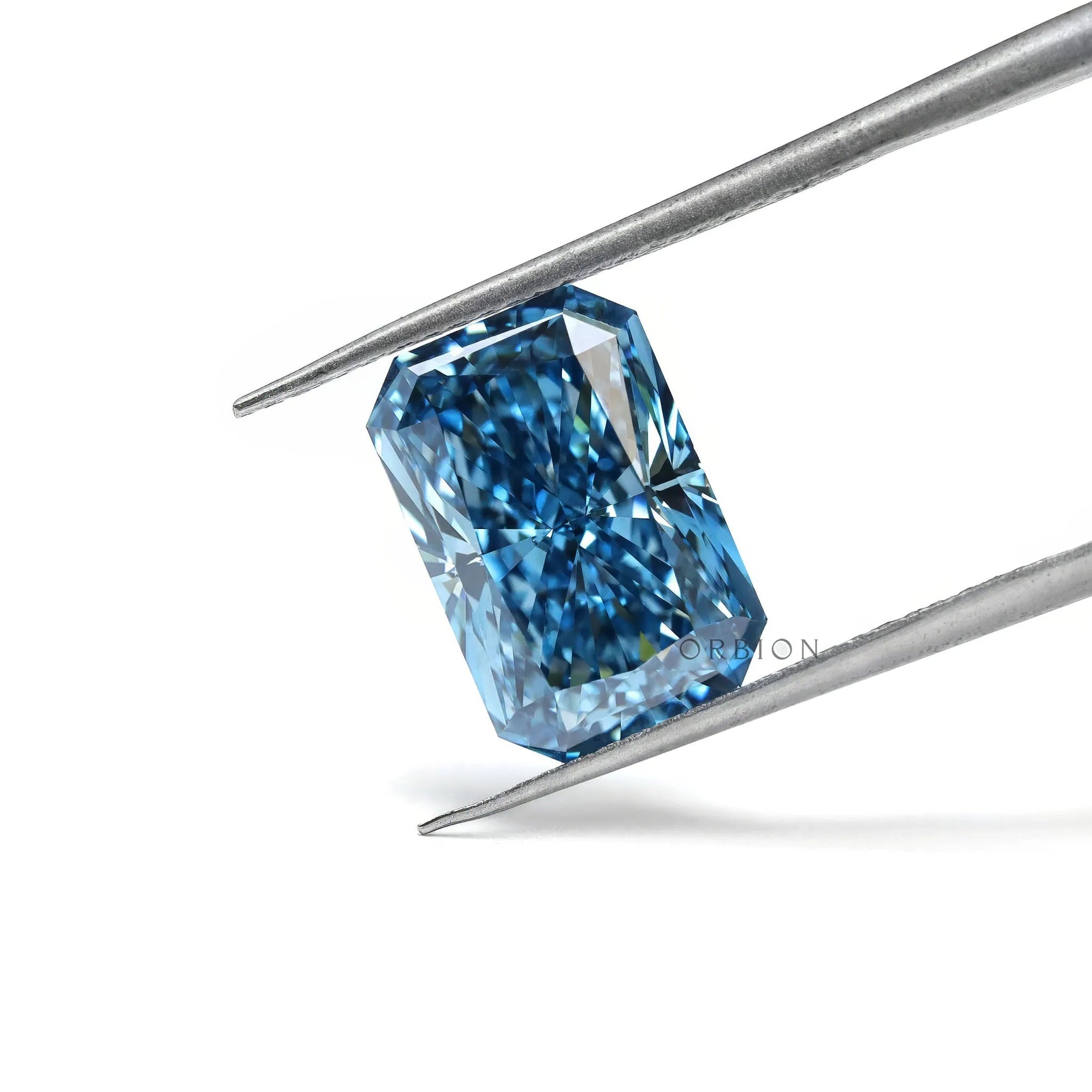 Radiant blue lab diamond tilted in tweezers on white background