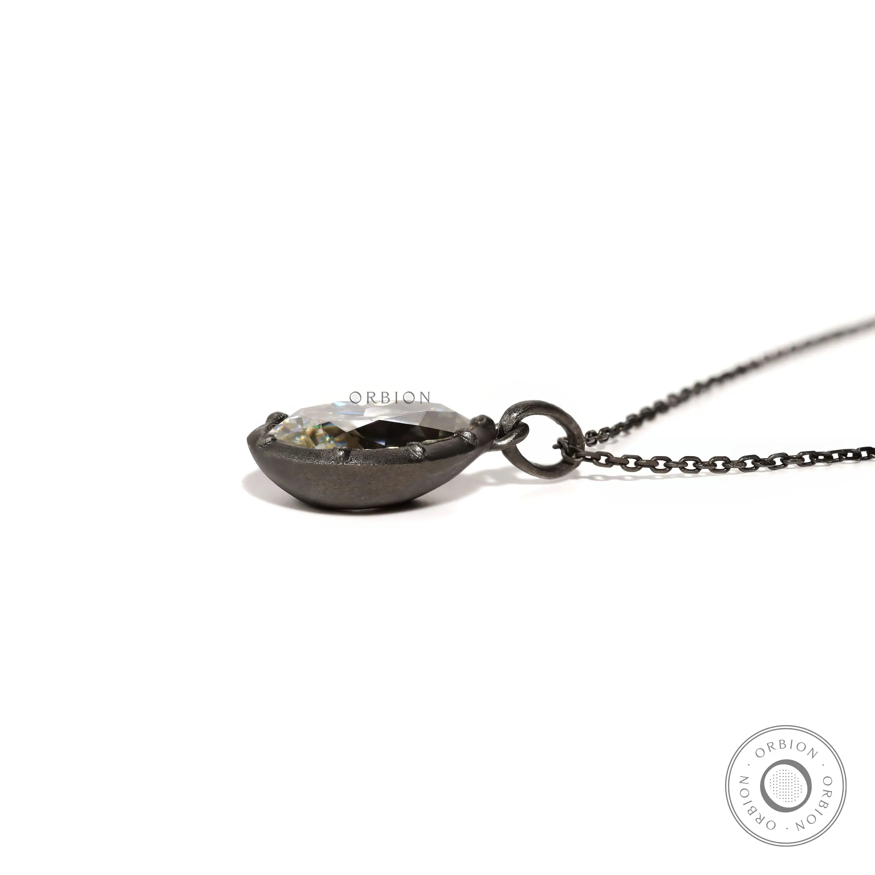 Low side view of pear moissanite pendant on chain