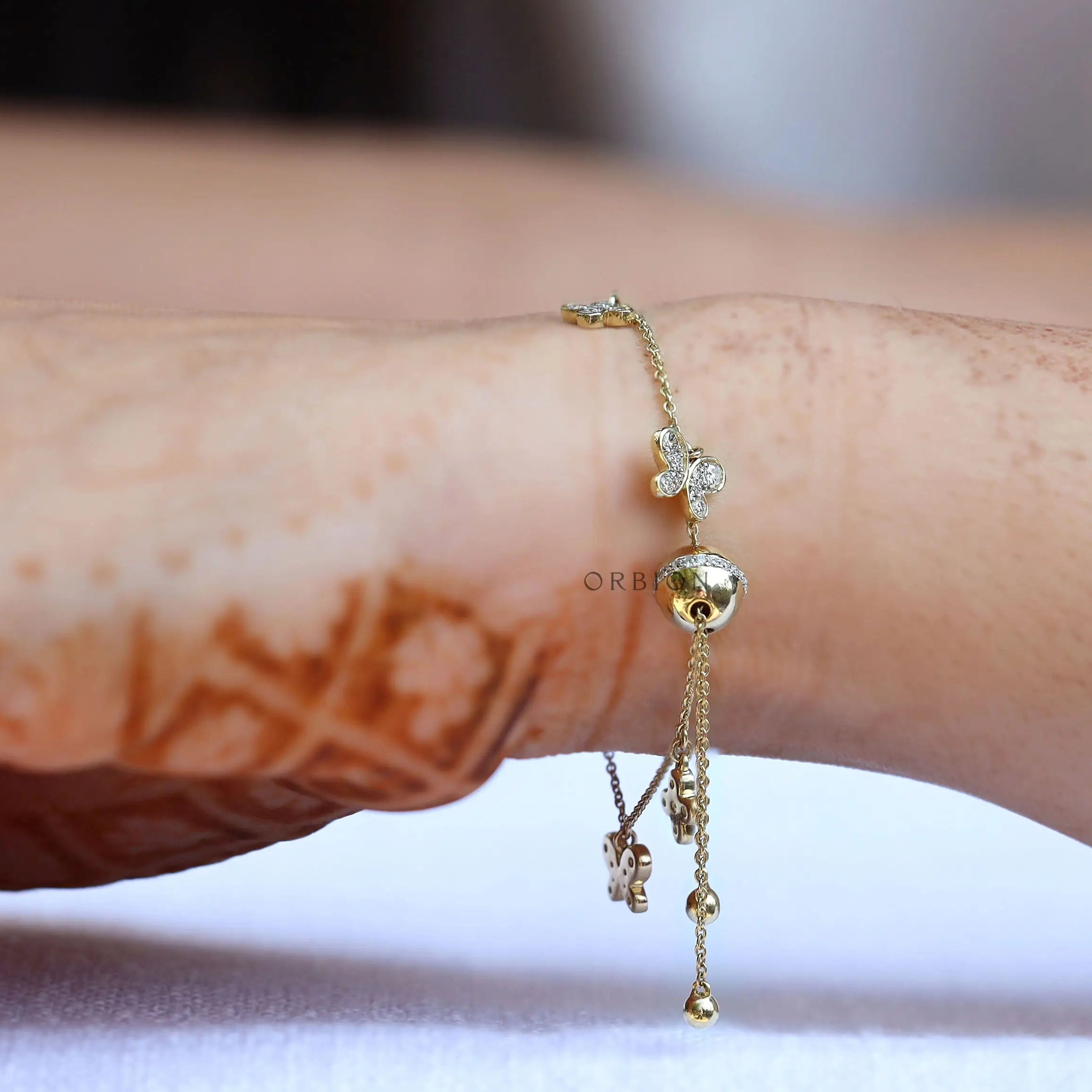 Side worn view adjustable butterfly clover charm bolo bracelet