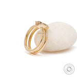 Angled view elongated cushion champagne moissanite bezel ring gold