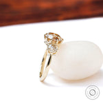Side angled champagne moissanite three stone engagement ring