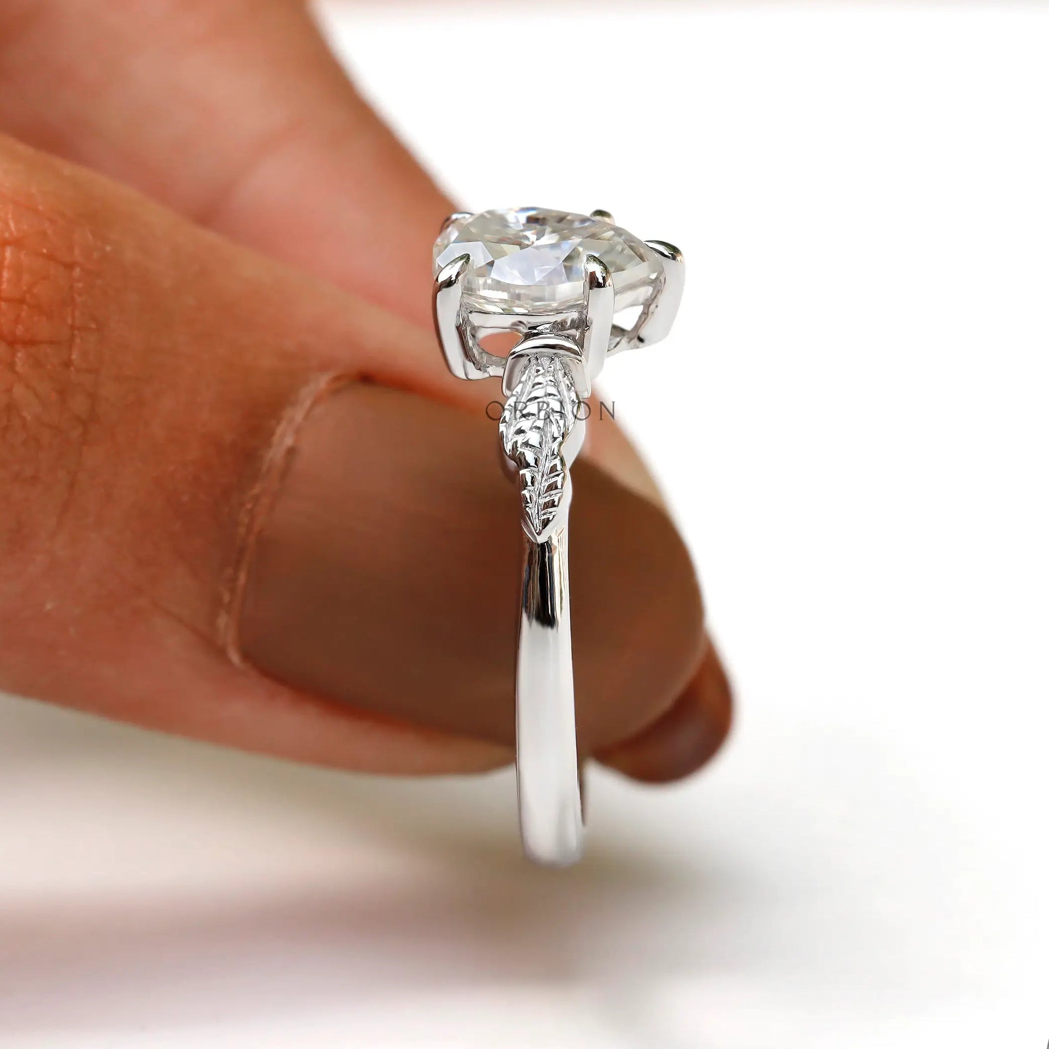 Close-up view of leaf engravings on Moissanite engagement ring band