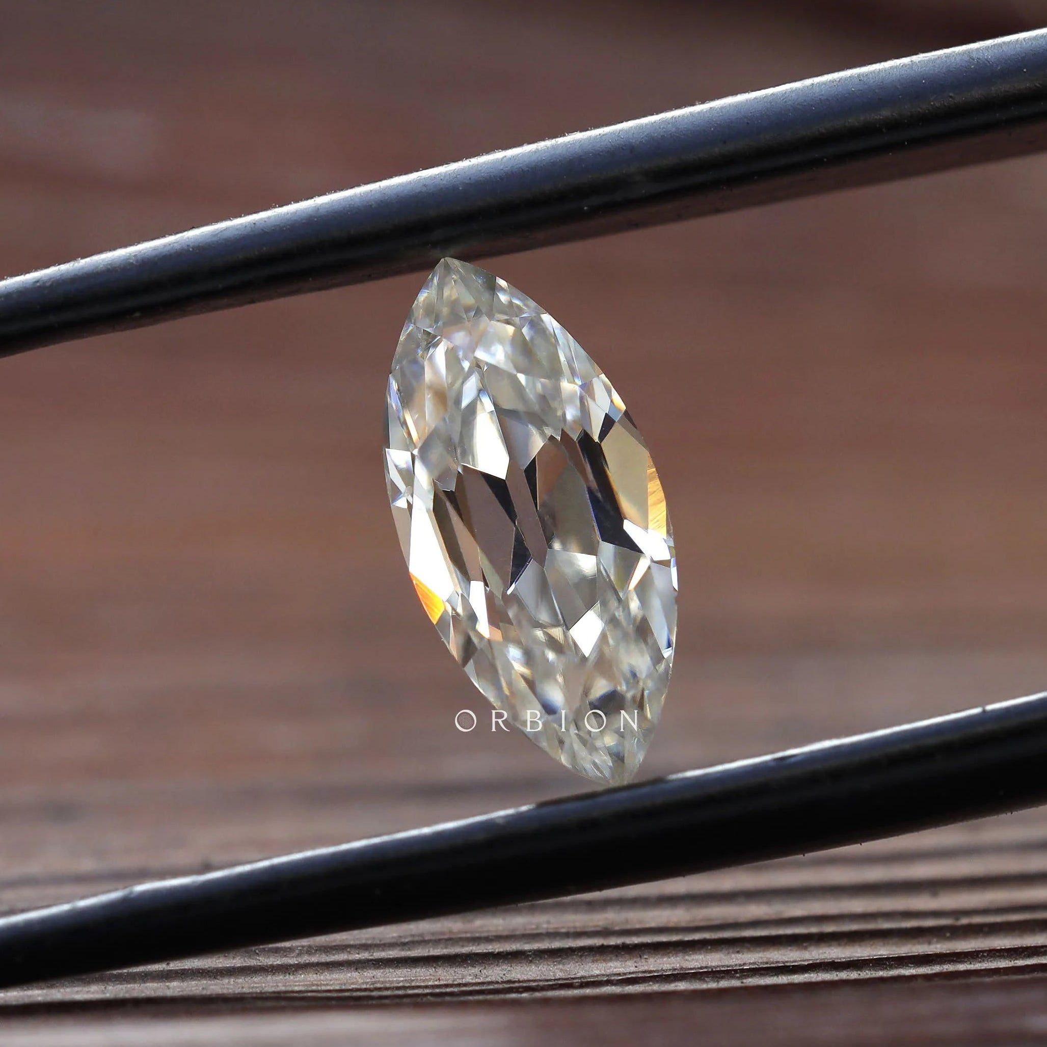 Beautifully cut 1.26 ct marquise moissanite with rainbow reflections