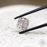 Front view cushion brilliant loose moissanite on light surface