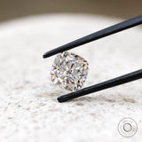 Front view cushion brilliant loose moissanite on light surface