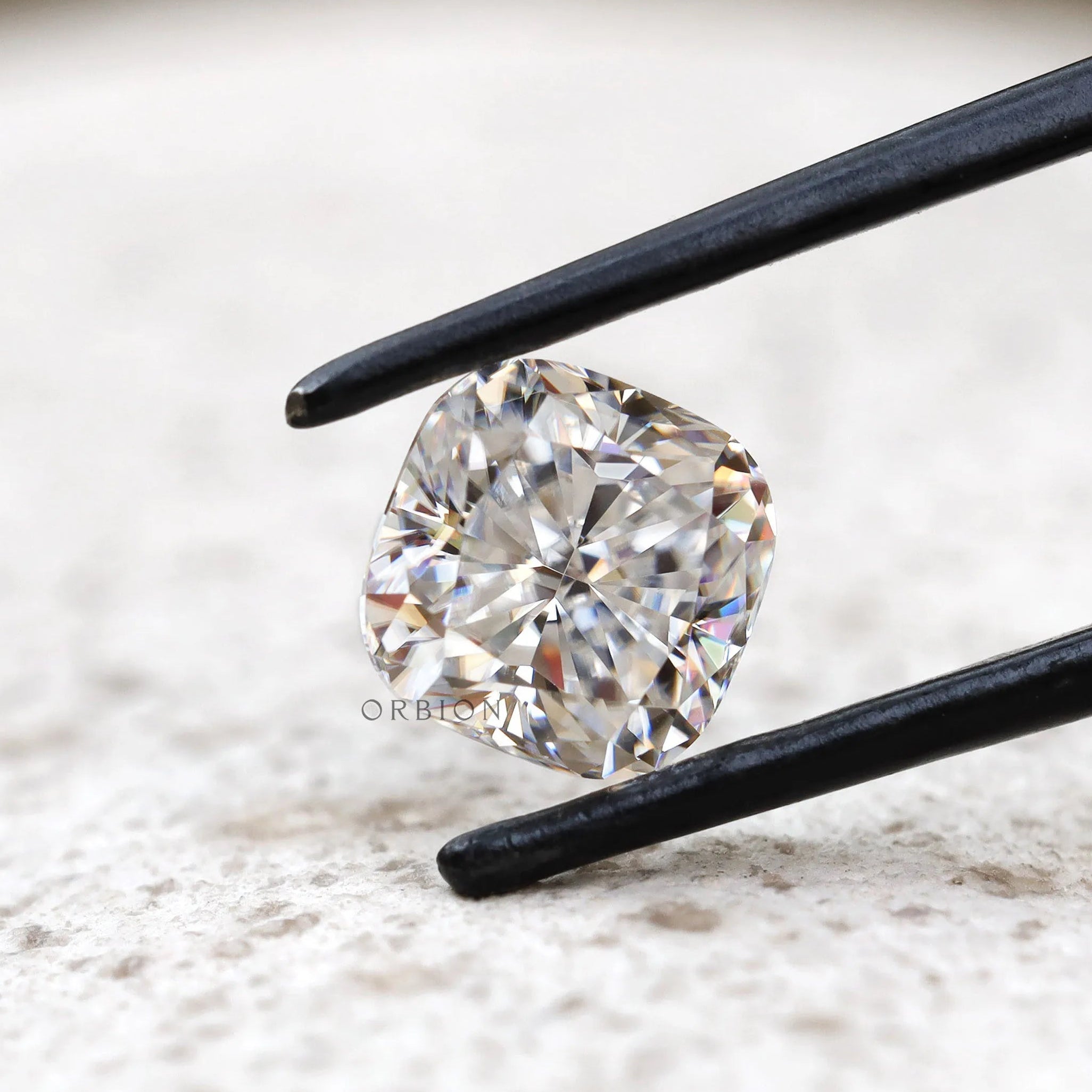 Front view cushion brilliant loose moissanite on light surface