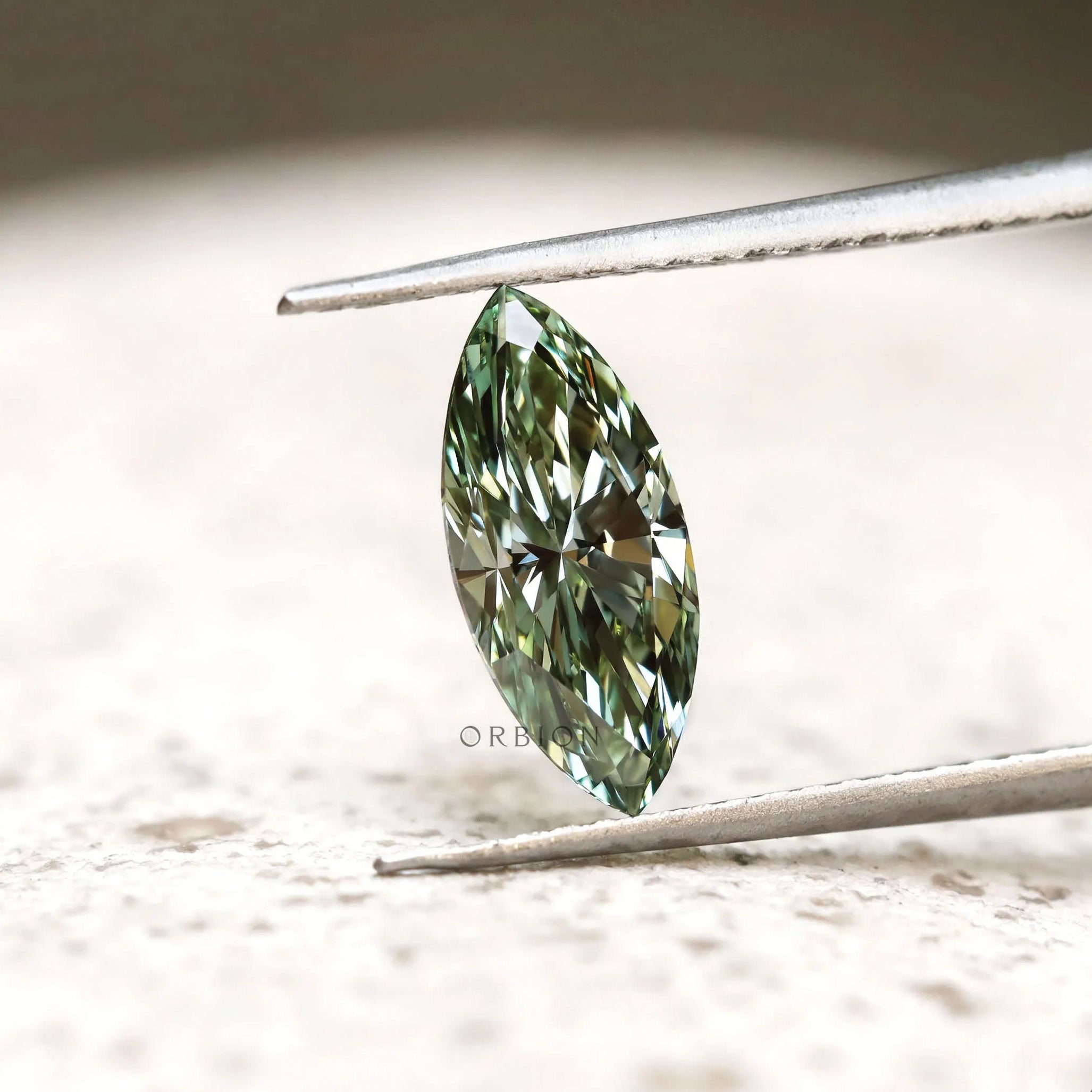 Green marquise brilliant cut loose diamond on display
