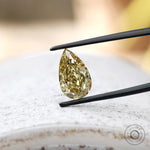 Loose pear brilliant cut brownish yellow diamond face down