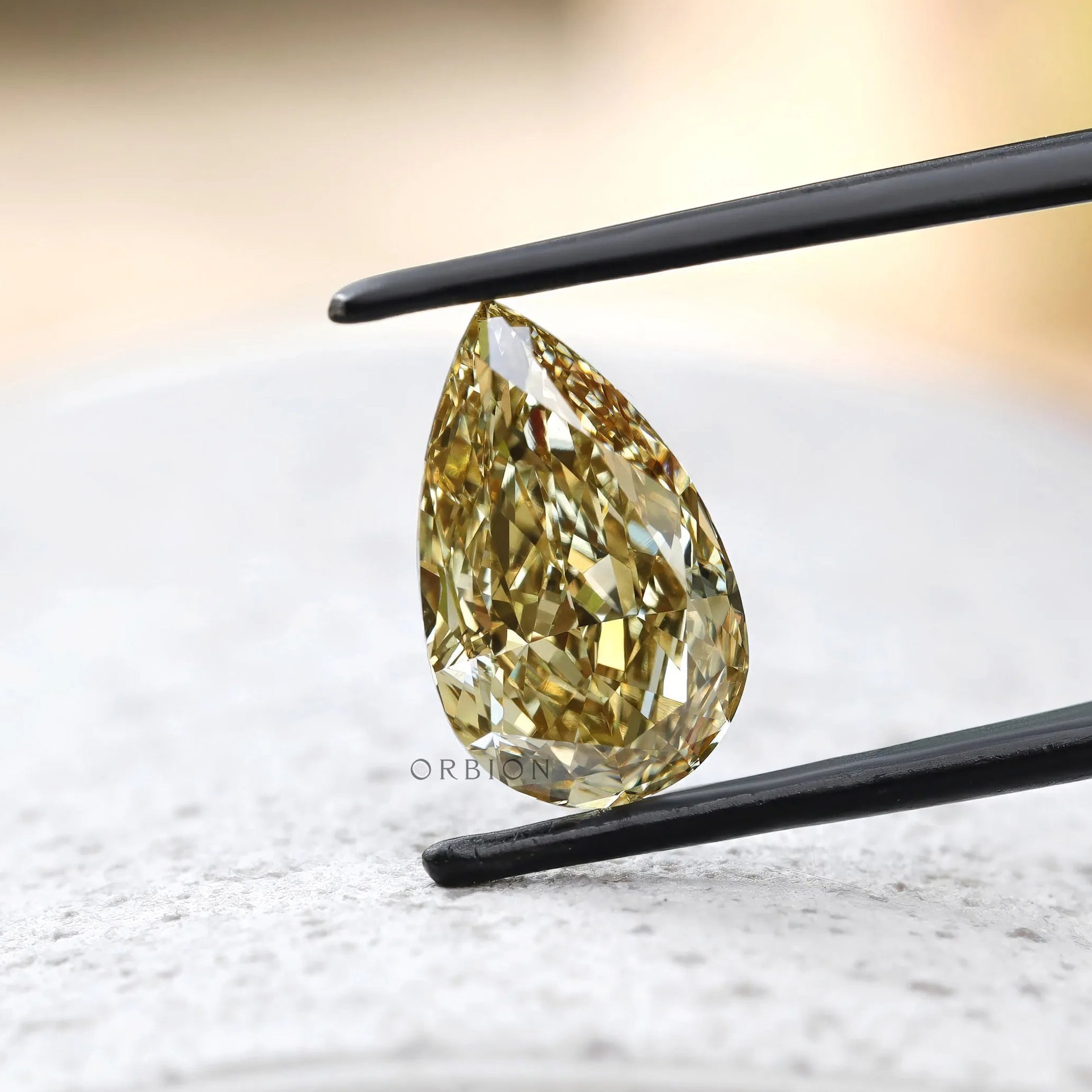 Loose pear brilliant cut brownish yellow diamond face down