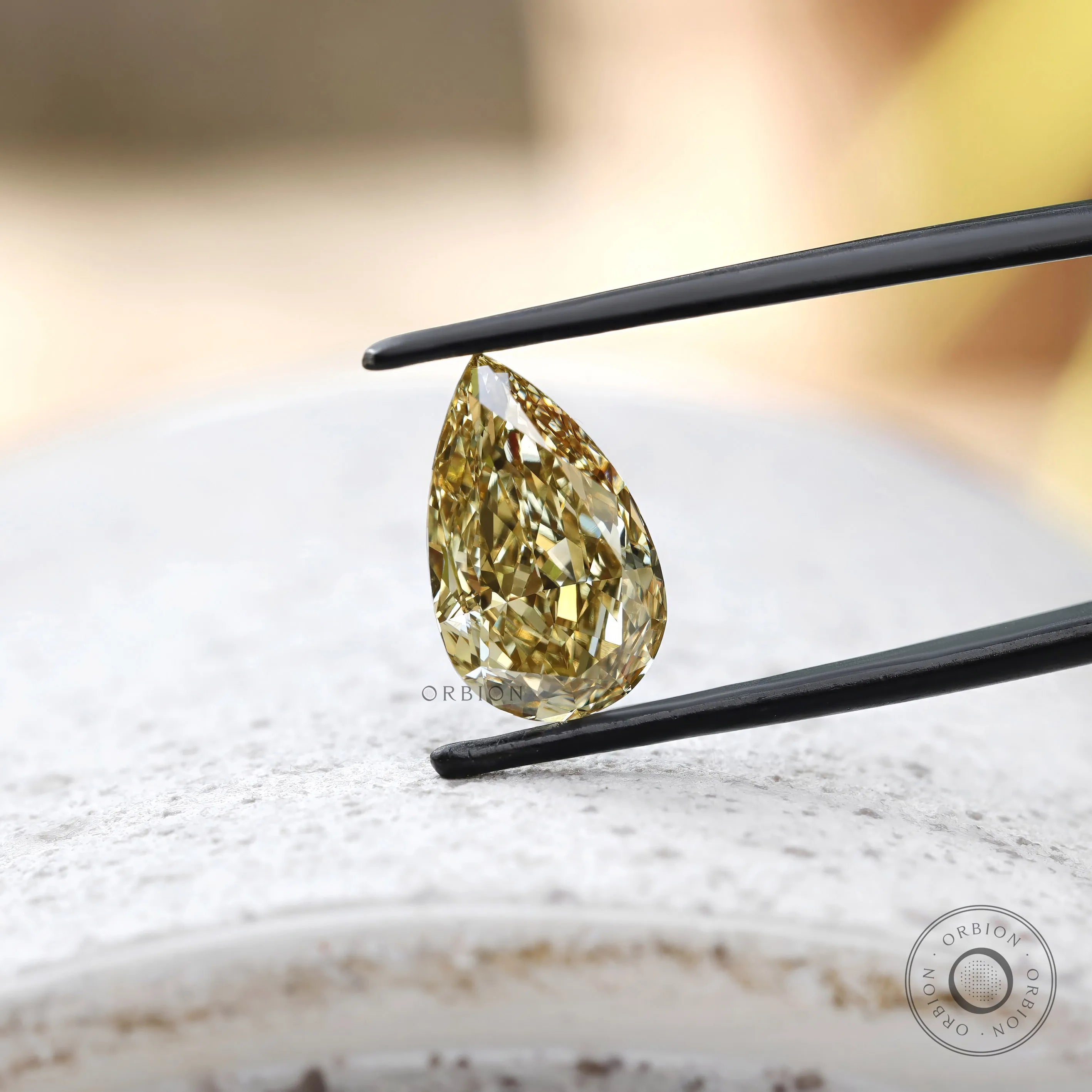 Loose pear brilliant cut brownish yellow diamond face down