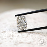 Centered elongated cushion crushed ice lab diamond in tweezers
