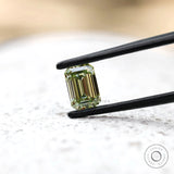 Fancy green emerald lab diamond on white surface