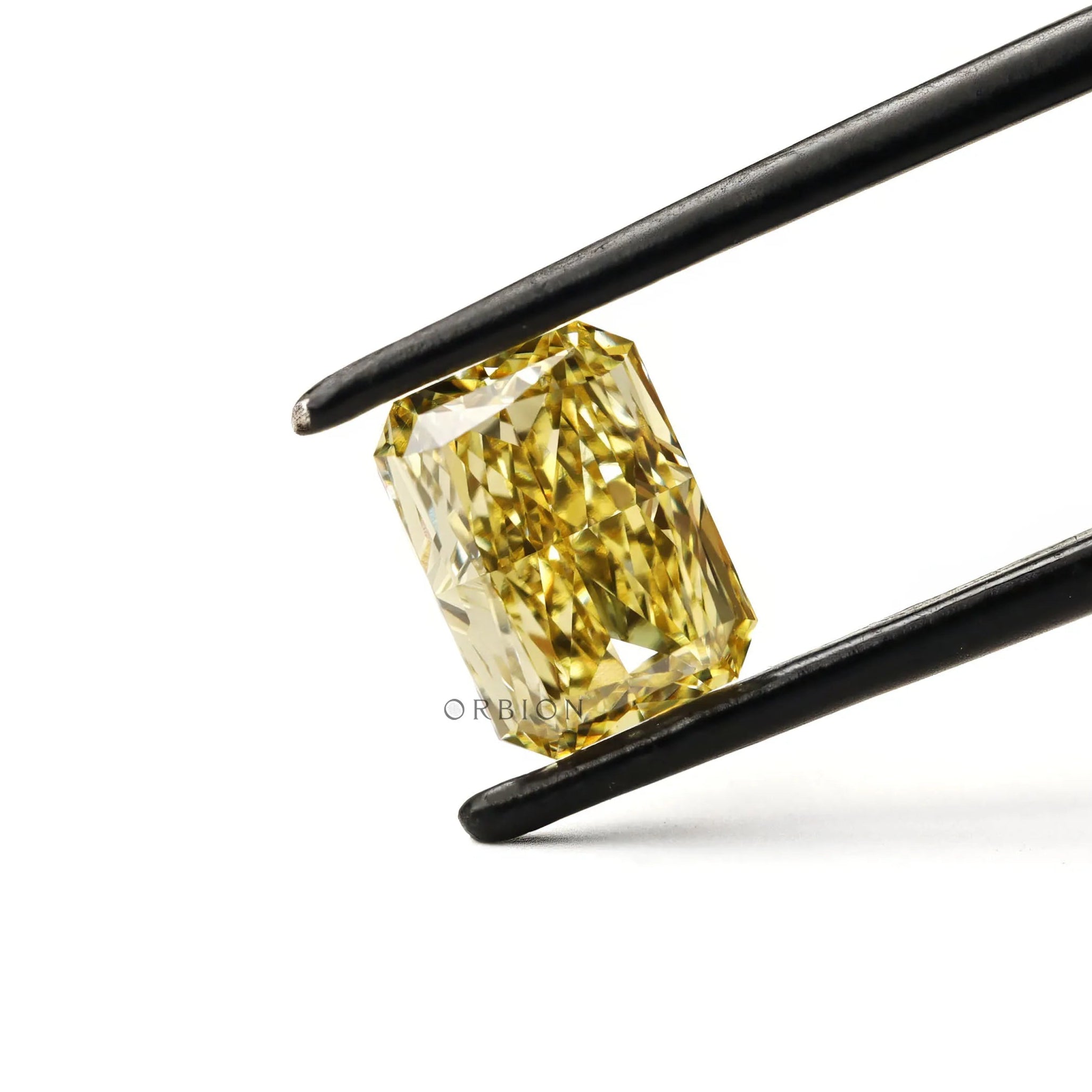 Radiant cut yellow loose lab diamond tilted in tweezers
