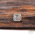 Face-up cushion loose lab diamond on wooden background
