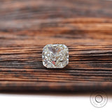 Face-up cushion loose lab diamond on wooden background