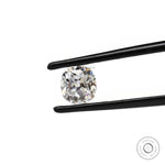 Elongated cushion moissanite stone shown at angled tweezer view