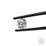 Elongated cushion moissanite stone shown at angled tweezer view