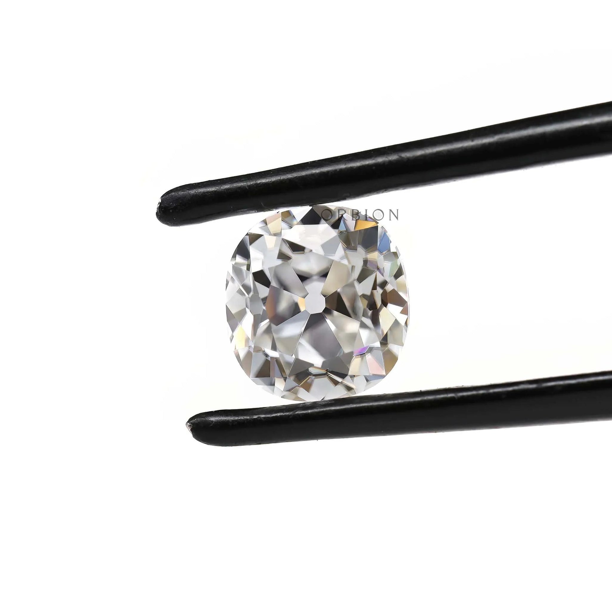 Elongated cushion moissanite stone shown at angled tweezer view
