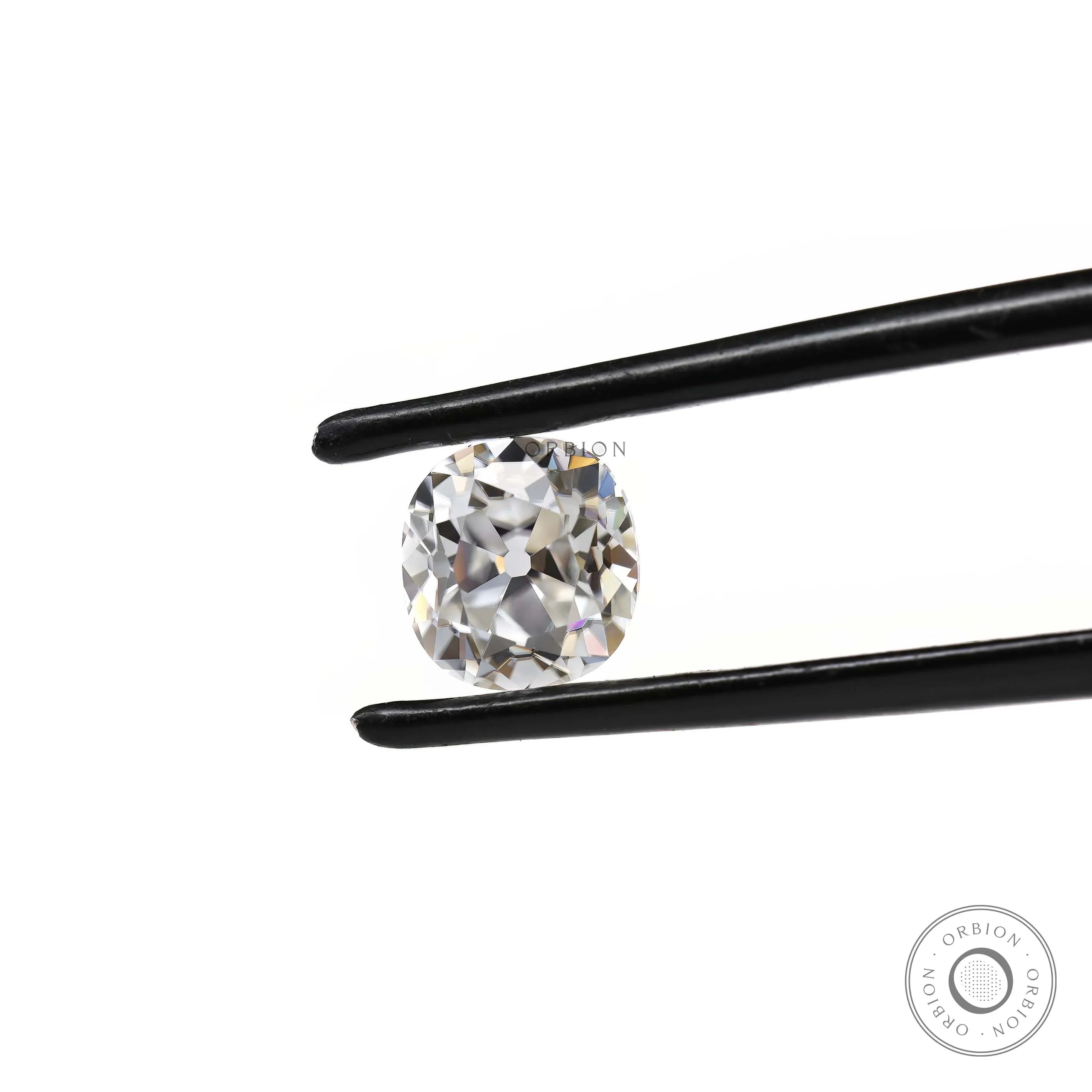 Elongated cushion moissanite stone shown at angled tweezer view