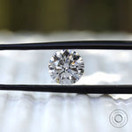 Brilliant cut round loose diamond shown in tweezers