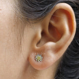 Elegant lotus flower stud earrings with yellow diamond in white gold.