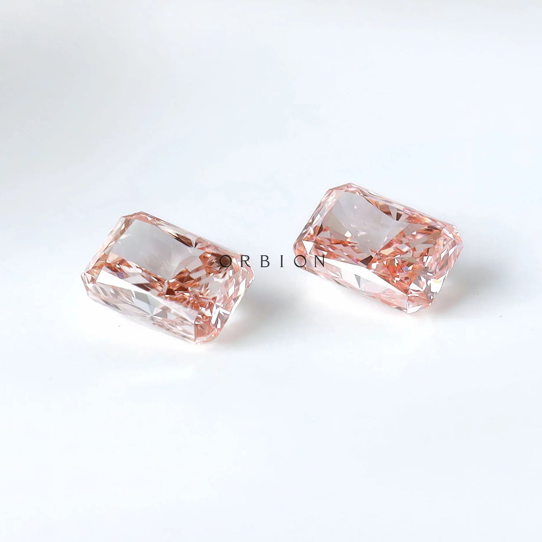 Two radiant pink lab diamonds shown pavilion side