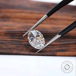 Back view of oval lab diamond with pointed tweezers