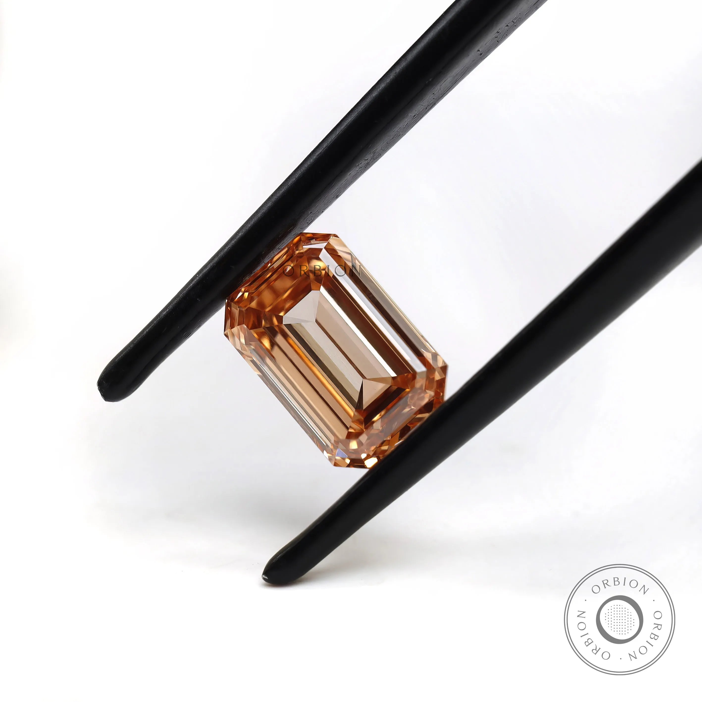 Horizontal view of fancy orange emerald lab diamond
