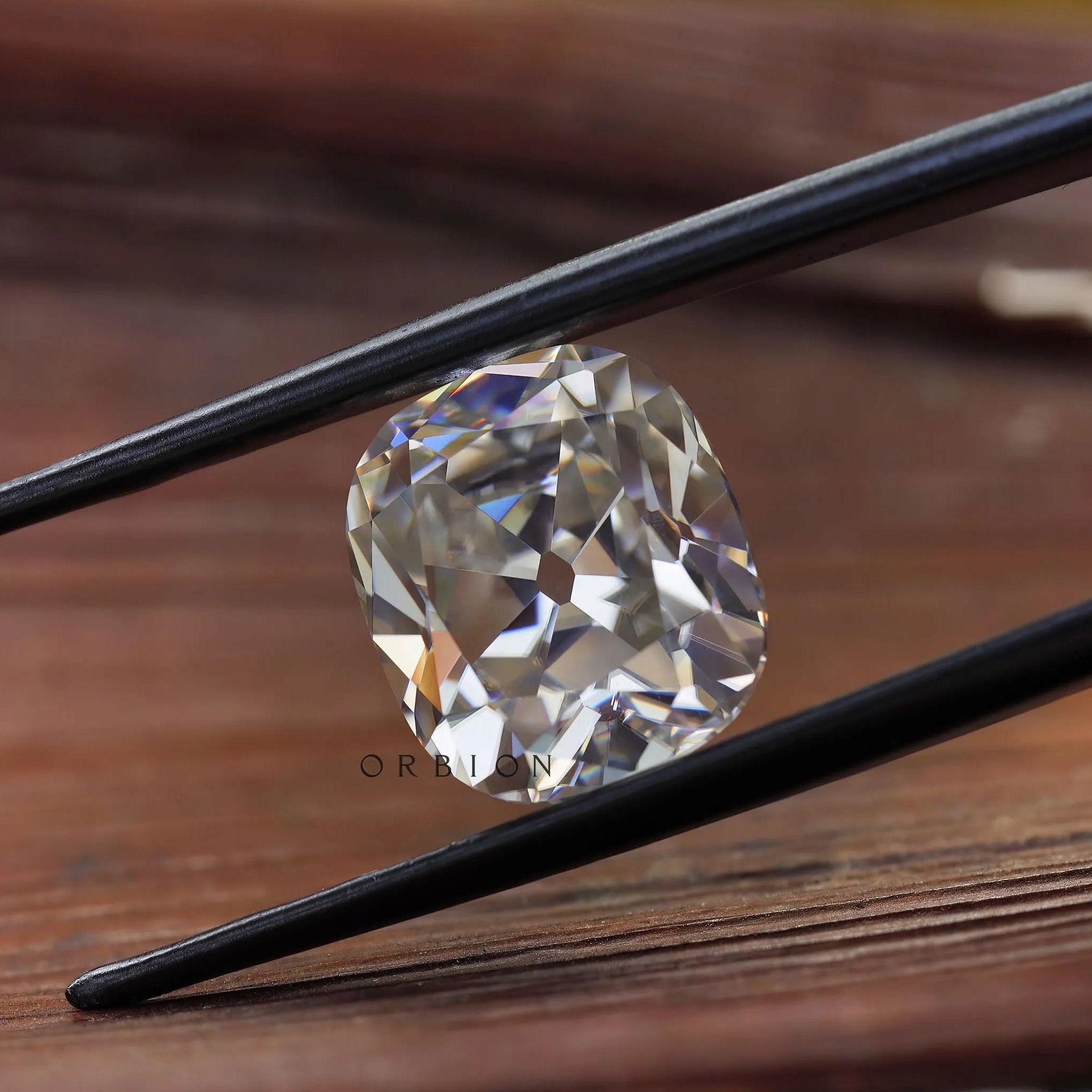 Cushion moissanite side profile on light wood surface