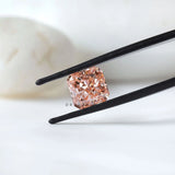 Angled radiant pink lab diamond in black tweezer display