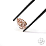 Angled tweezers view of pear pink loose diamond