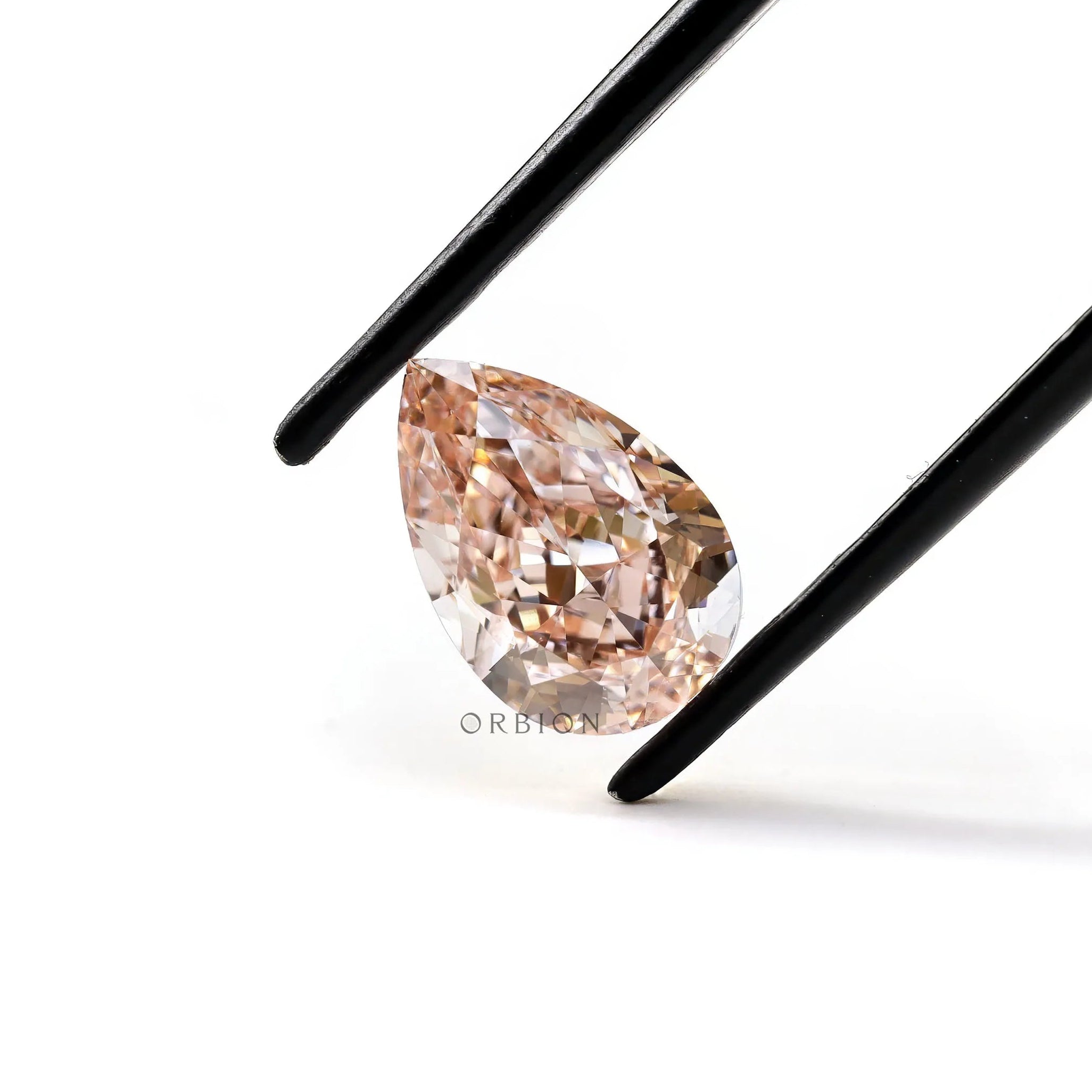 Angled tweezers view of pear pink loose diamond