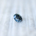Profile side view of round intense blue loose diamond