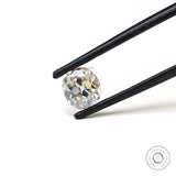 Old mine cut elongated cushion moissanite shown in tweezers