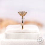 Side profile of elongated cushion moissanite ring on stand