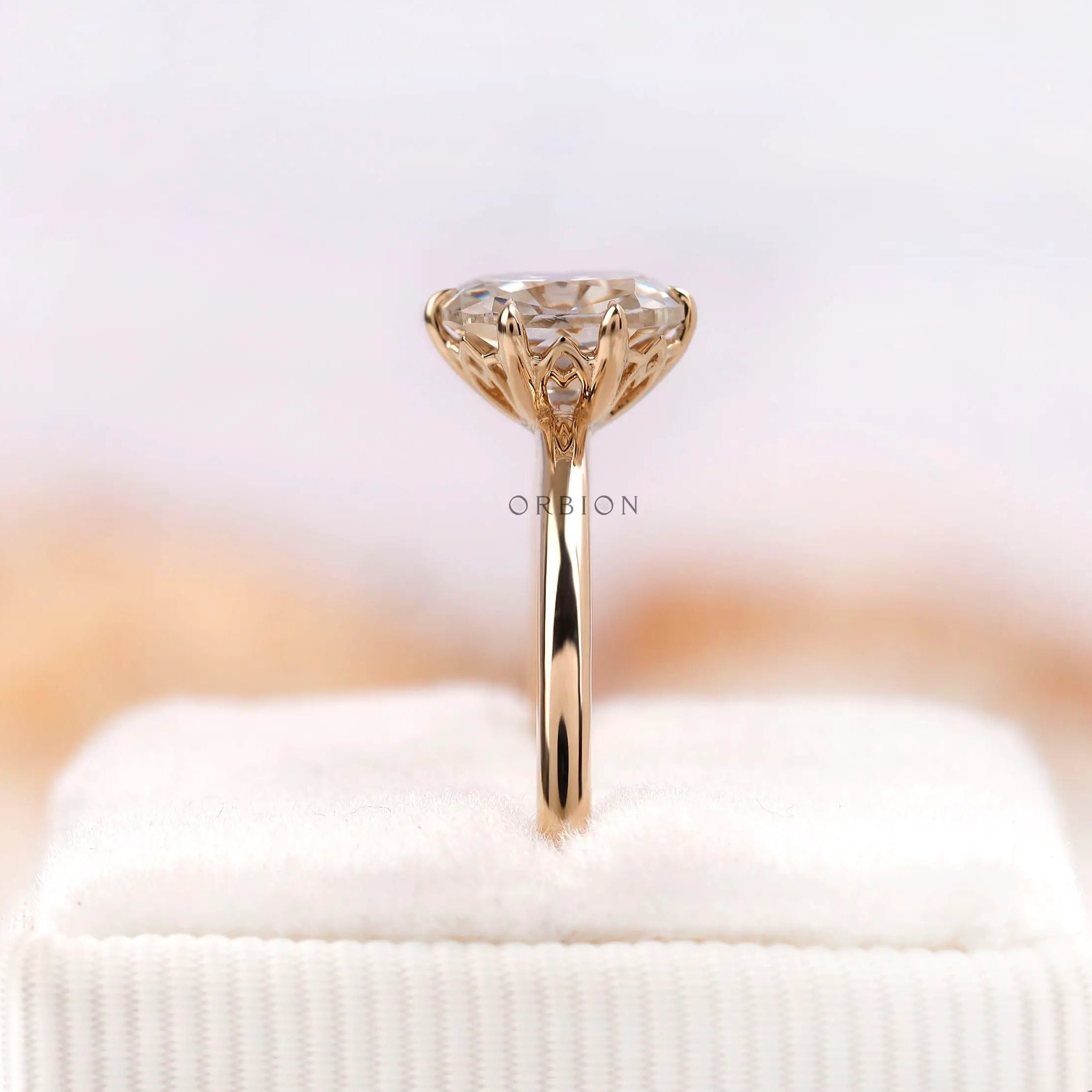 Side profile of elongated cushion moissanite ring on stand