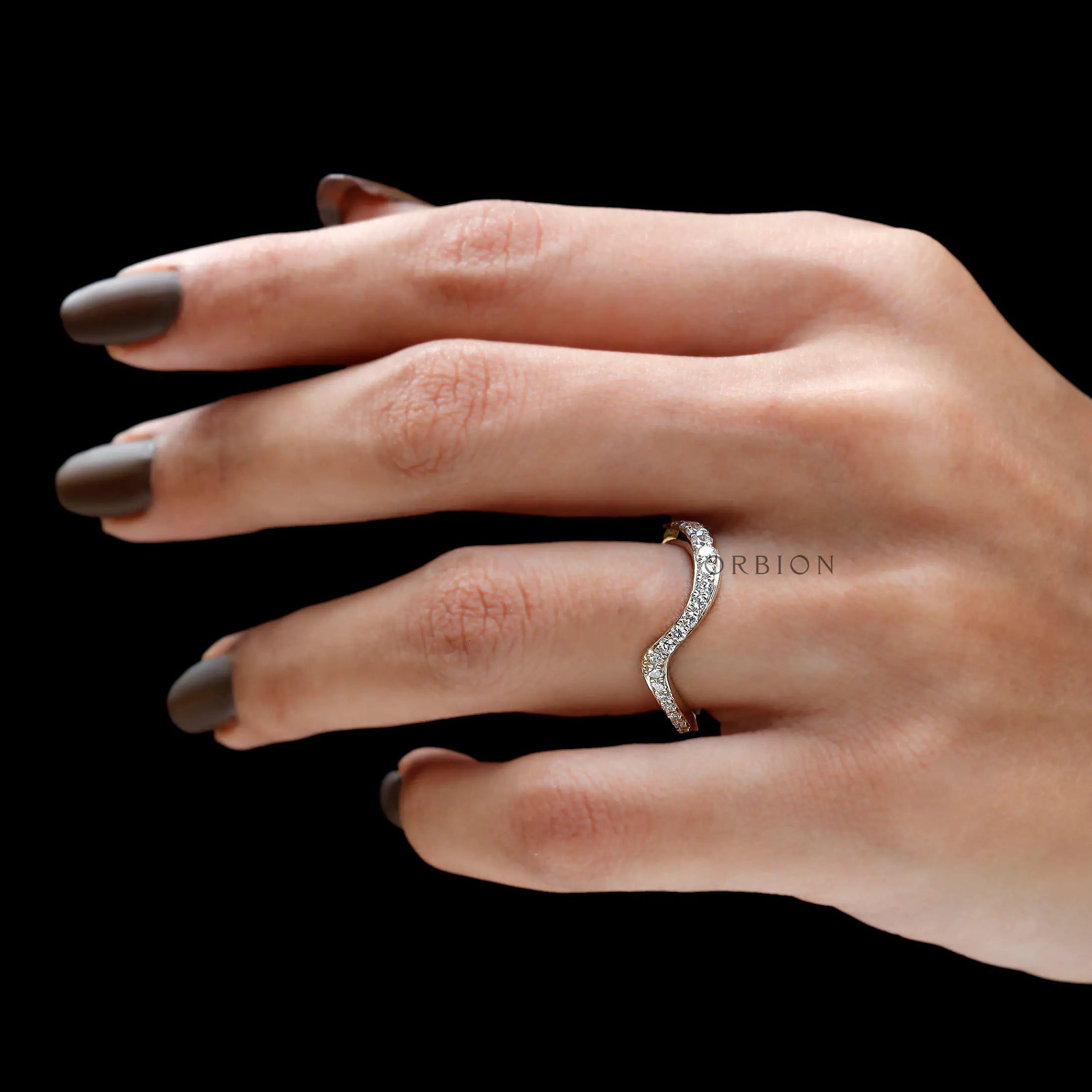 Curved diamond band fitting on a finger