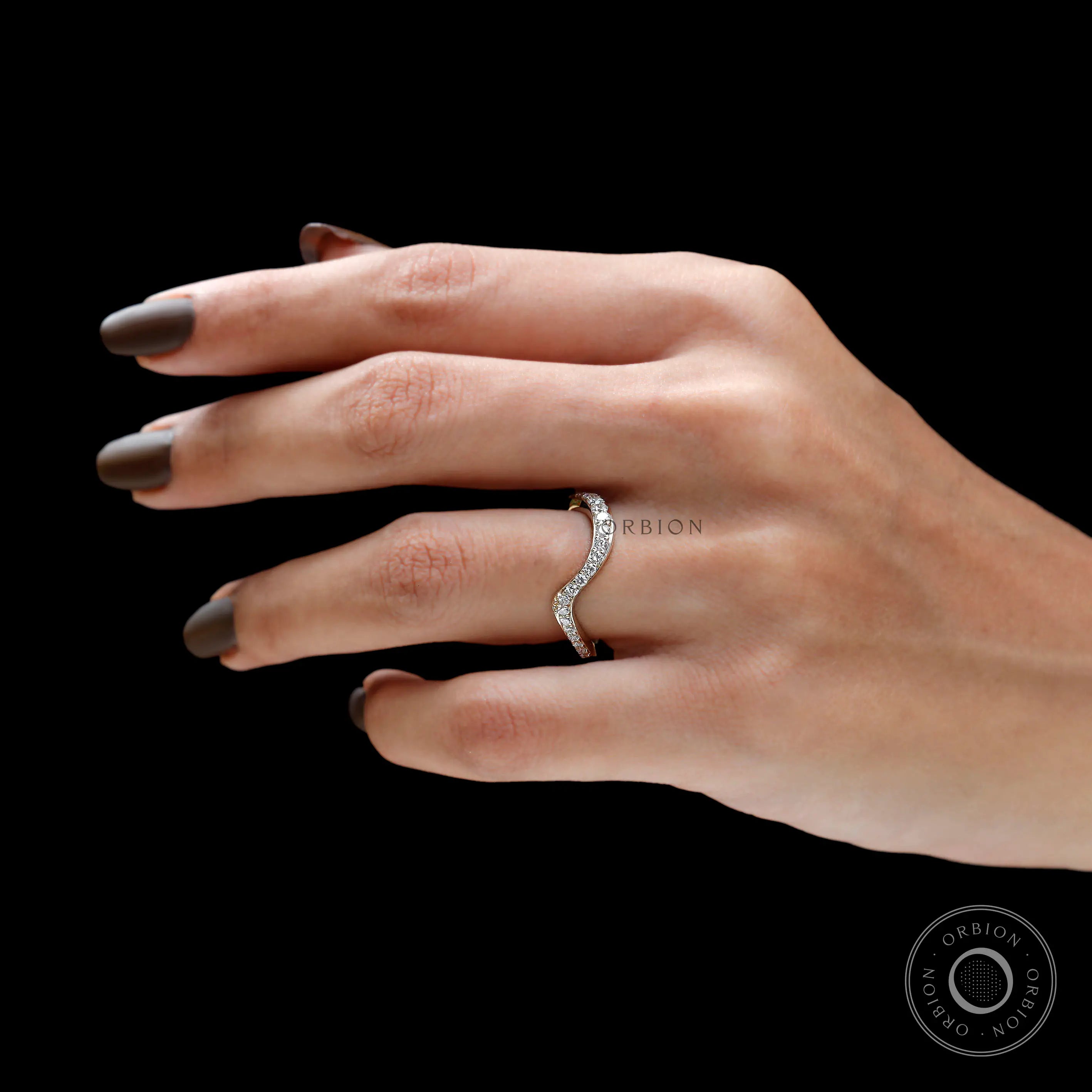 Curved diamond band fitting on a finger