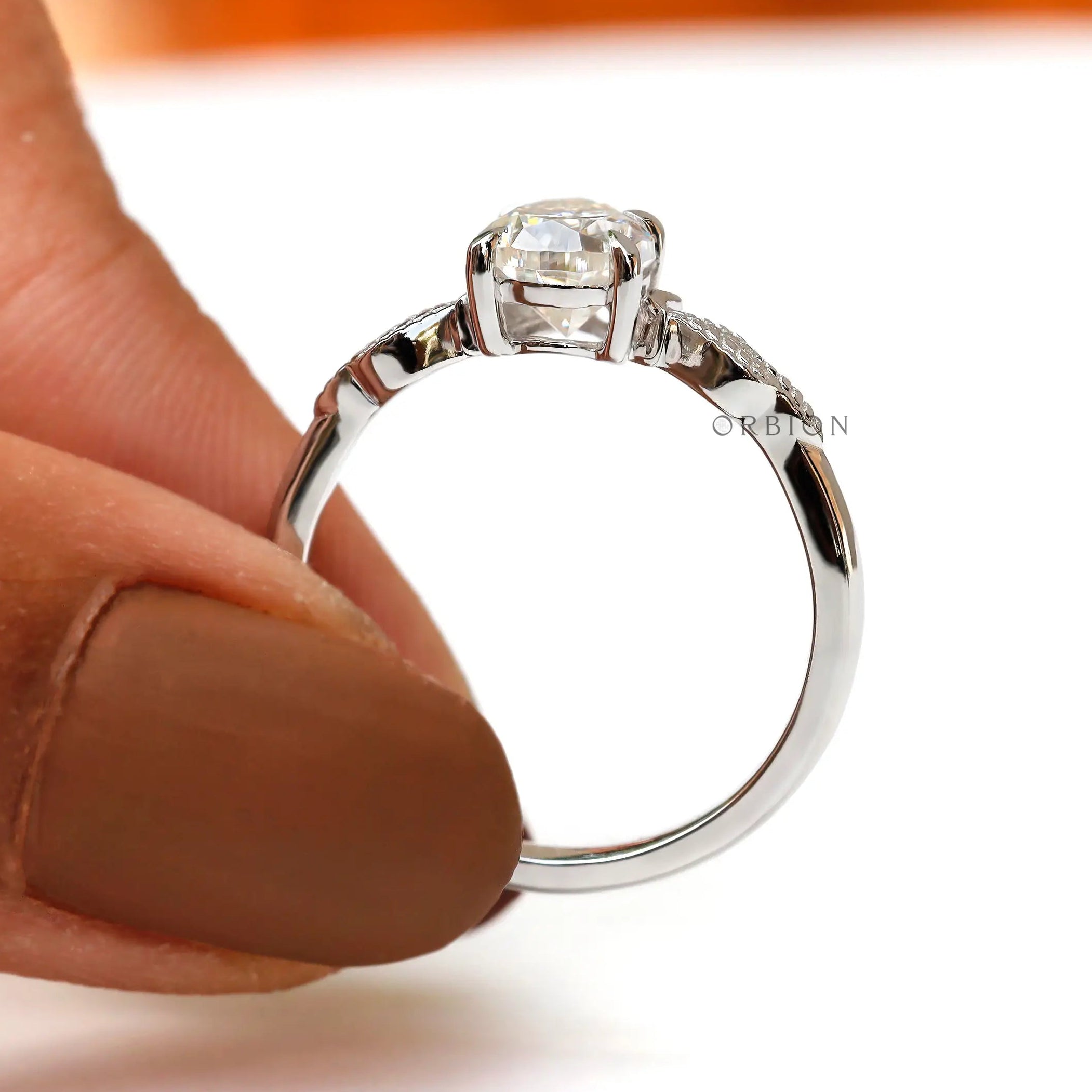Another side view showcasing the pear-shaped Moissanite ring