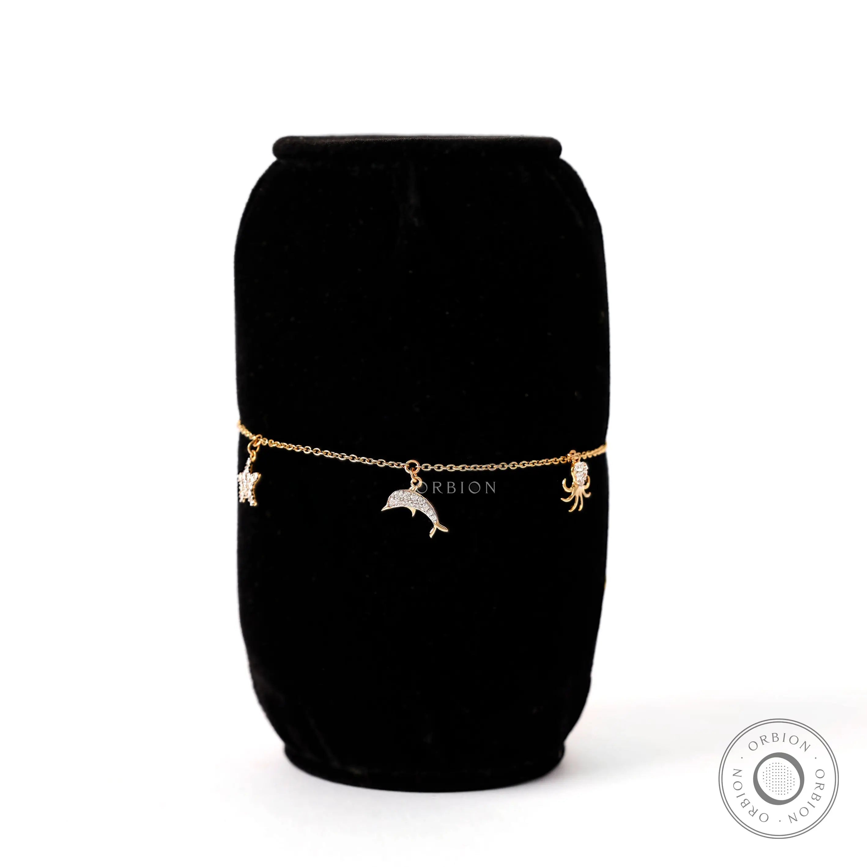 Charm detail view dolphin octopus bracelet in yellow gold