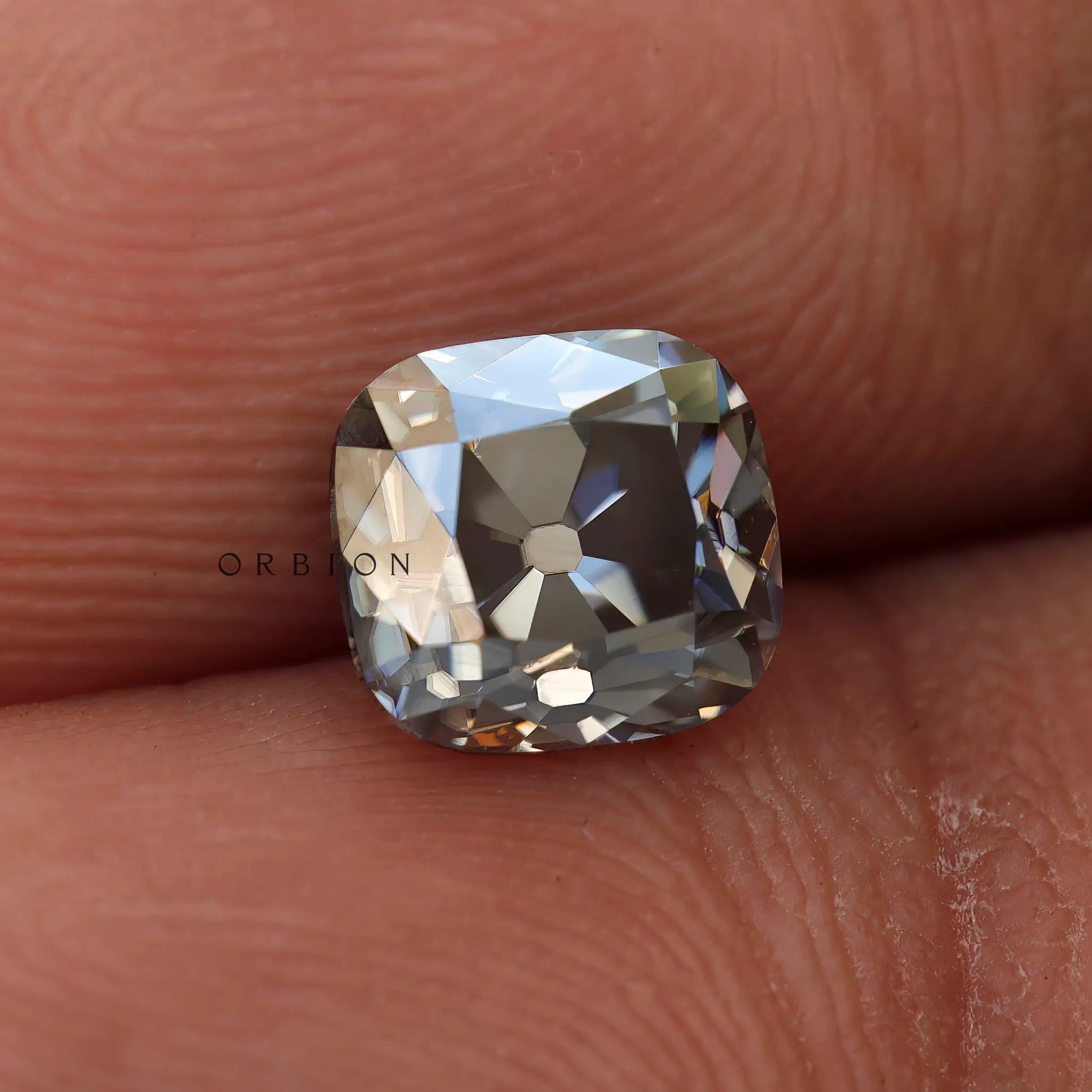 1.7 CT Old Mine Cut Cushion Moissanite Stone Held in Hand