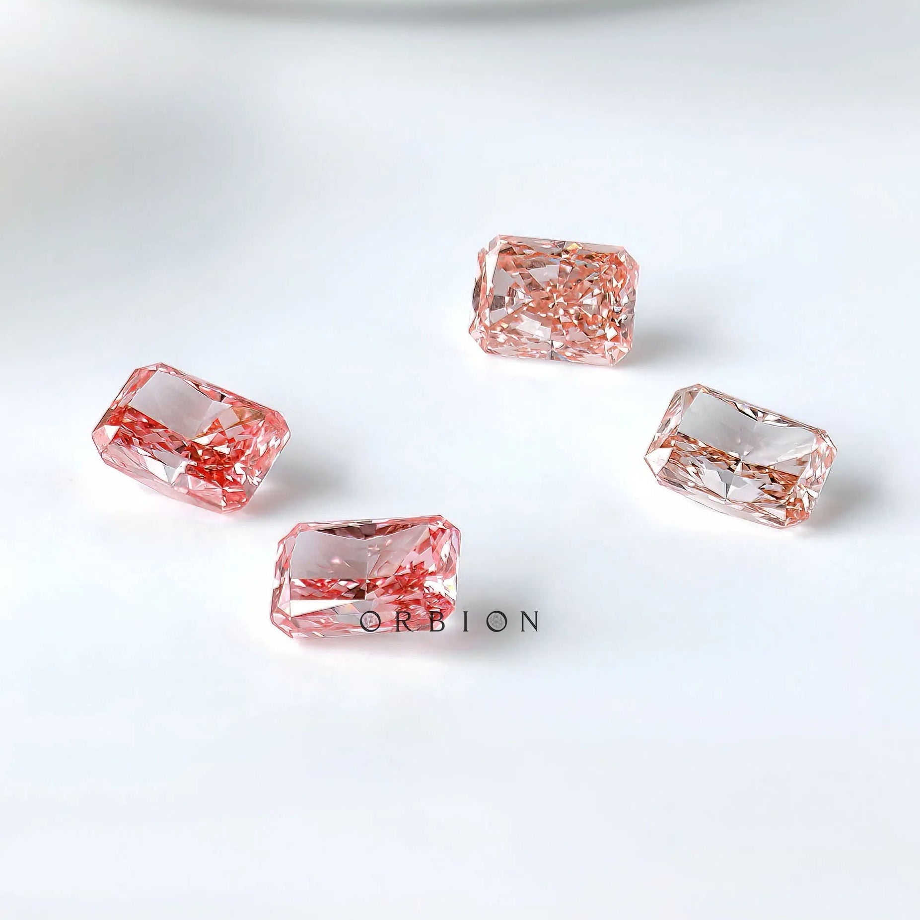 Group shot of four radiant pink lab diamonds