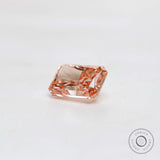 Loose fancy pink radiant diamond resting on white surface