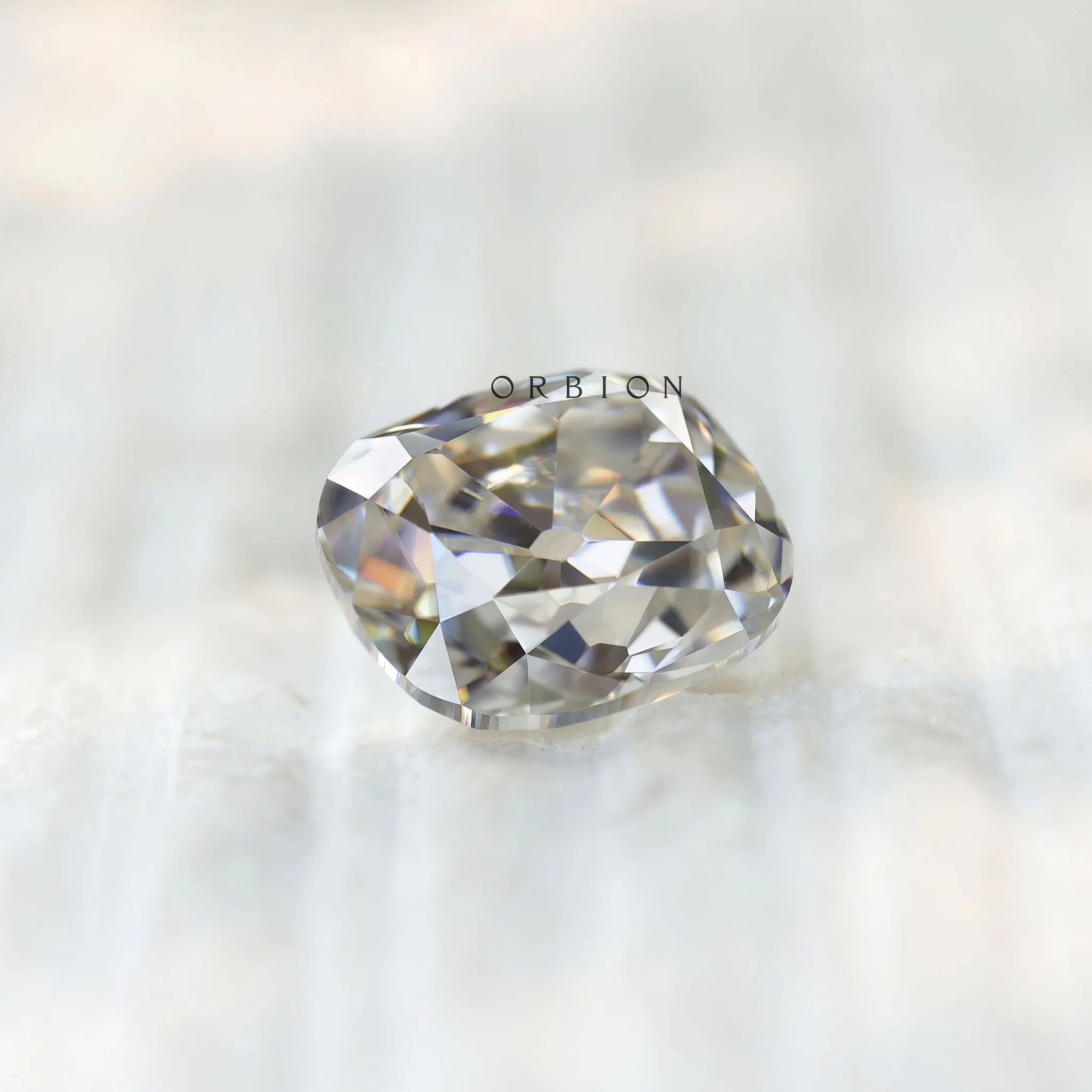Cushion moissanite side profile on light textured surface